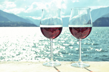 Two wineglasses against lake Como, Italy