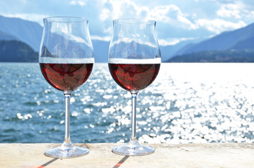 Two wineglasses against lake Como, Italy