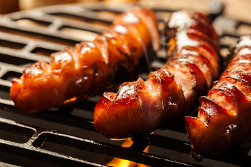 Grilling sausages on barbecue grill