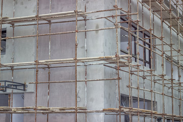 Building covered with scaffolding at construction site 2