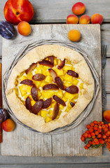 Top view of galette with plum, pumpkin and peach.