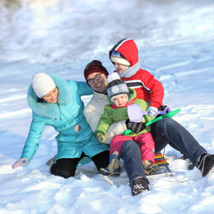 young family having fun in the snow