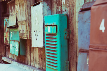 Old memory mailboxes concept. Multicolored old shabby mailboxes