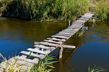 Fototapeta na wymiar wooden bridge on river