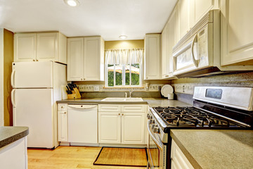 Simple white kitchen with granite tops