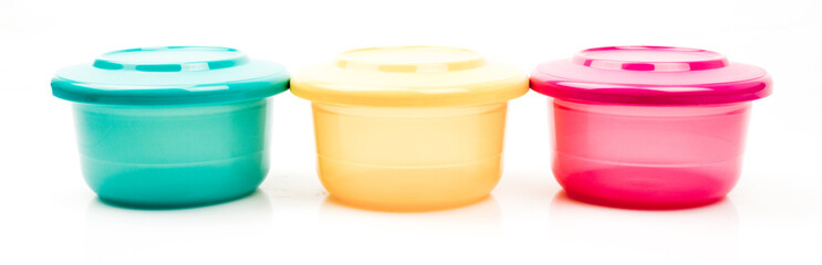 Glossy color food plastic containers isolated on white backgroun