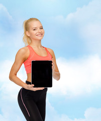 smiling woman showing tablet pc blank screen