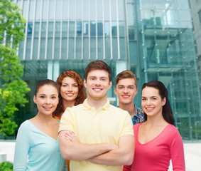 group of smiling teenagers over city background