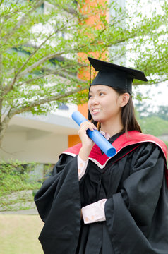 asian female student in graduate gown