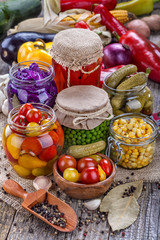 Several kinds of healthy domestic canned vegetables in jars