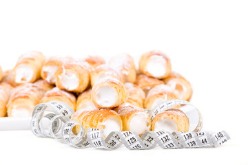 concept of slimming, cakes with measuring tape