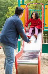 Obraz premium Asian dad and daughter on playground