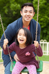 Asian family on a swing