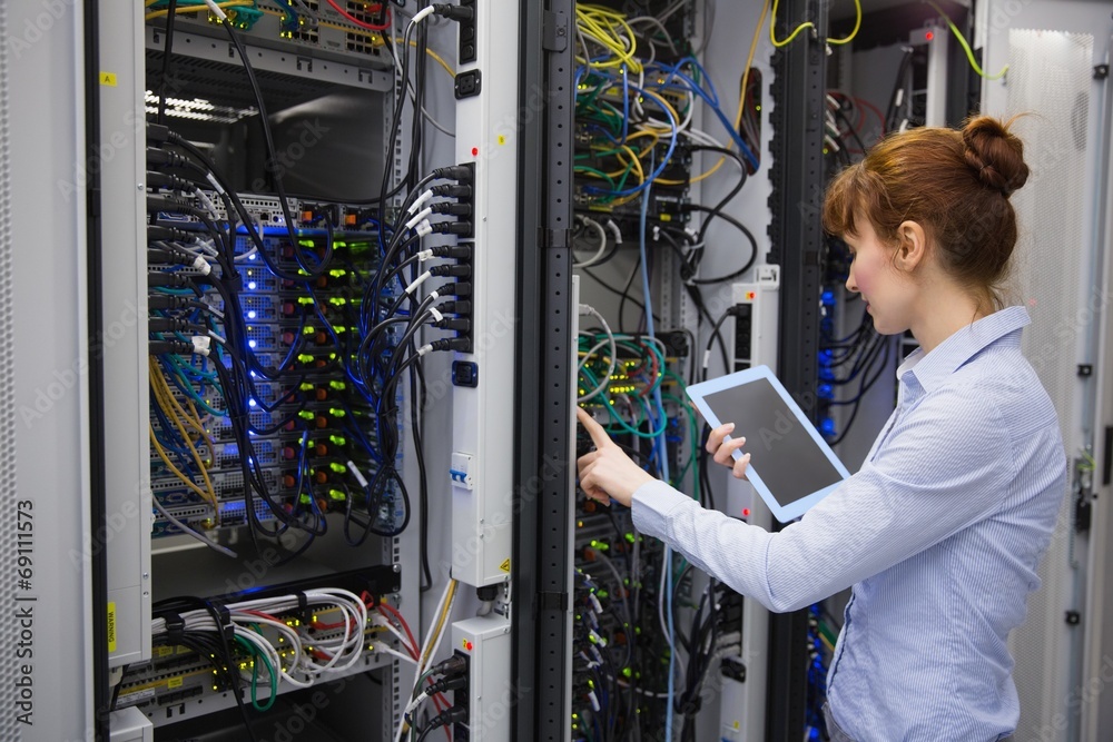 Aufkleber Technician using tablet pc while analysing server