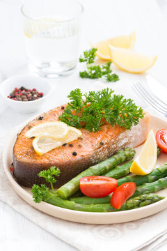 baked salmon with asparagus, parsley and lemon, vertical