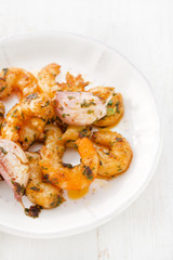 shrimps with garlic on white plate