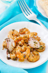 fried shrimps with garlic on white plate