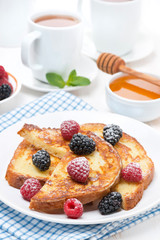 French toast with berries and powdered sugar for breakfast