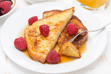 French toast with raspberries and maple syrup, top view