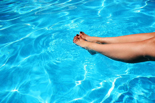 Closeup portrait of a woman's feet in a swimming pool
