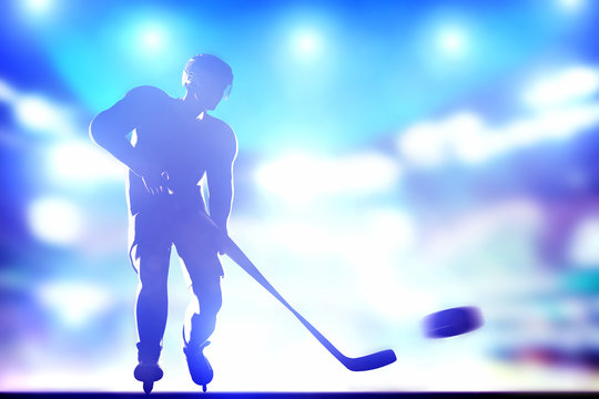 Hockey player shooting on goal in arena night lights
