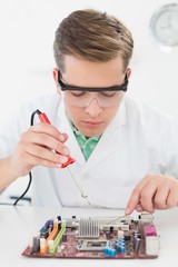 Technician working on broken cpu with soldering iron