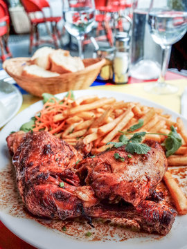 Chicken with sauce and golden French fries