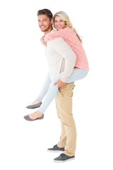 Handsome man giving piggy back to his girlfriend