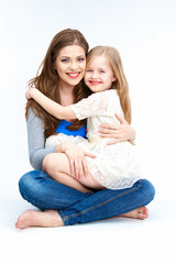 Mother and daughter sitting on a floor.