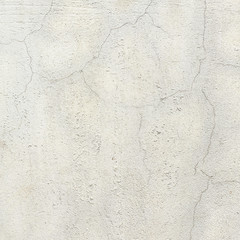 Cracked concrete painted white wall