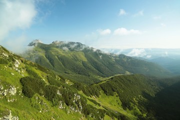 One of the peaks in the Carpathian Mountains seen from a trail on a sunny morning