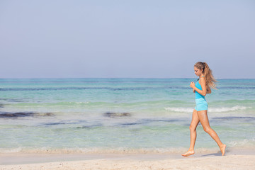 Fototapeta na wymiar fit healthy woman jogging or running on seashore