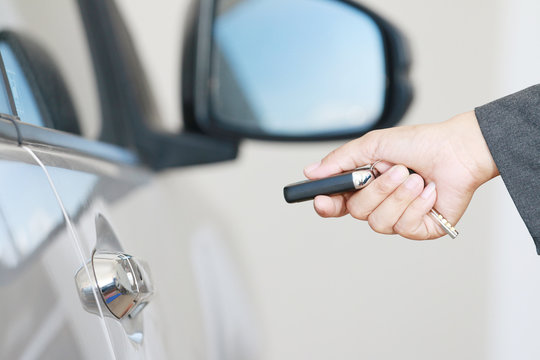 Business woman operate remote key car