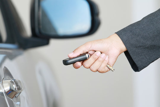 Bussiness woman show a remote car key