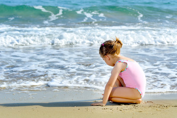 Fototapeta na wymiar Toddler girl at beach