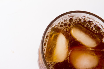 glass with ice tea full with ice cubes on white background