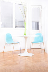 white bright living room interior with decorative flowers on the
