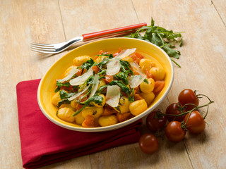 gnocchi with arugula tomato and parmesan cheese