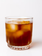 glass with ice tea full with ice cubes on white background