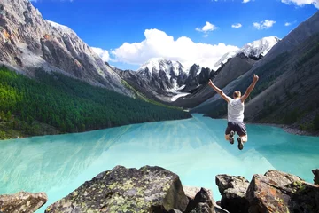 Fotobehang Beautiful mountain landscape with the lake and the jumping man © Ivanov Alexandr