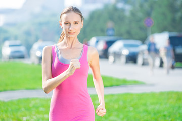 Fototapeta premium Jogging woman running in city park