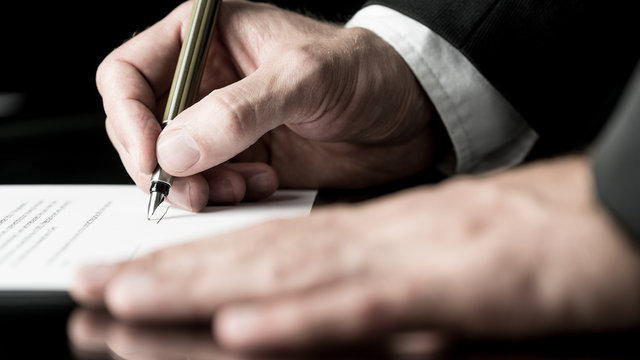 Desaturated image of signing a contract