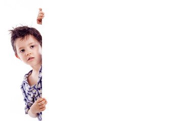 Kid holding a white board for text or image, isolated on white b