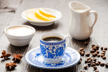 espresso in blue cup with lemon and honey on table