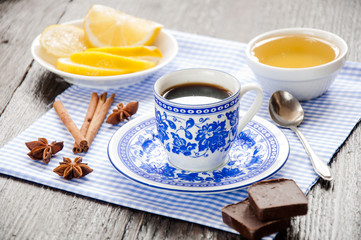 espresso in blue cup with lemon and honey on table