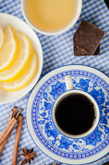 espresso in blue cup with lemon and honey on table