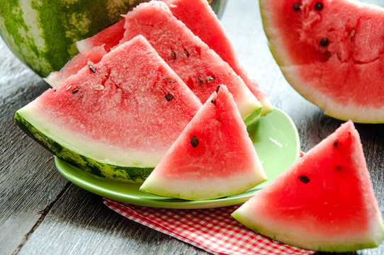 Ripe watermelons on table on the wooden background