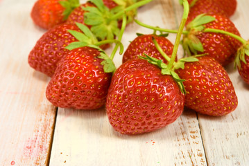 ripe and sweet strawberries on wooden table closeup