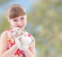 laughing girl holding a rabbit.