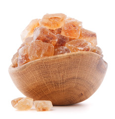 Brown cane caramelized lump sugar in wooden bowl isolated on whi